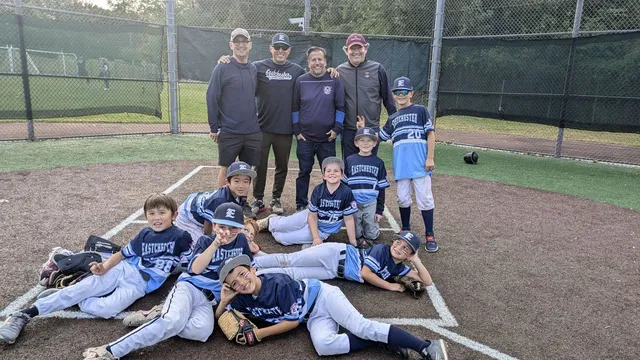 Eastchester little baseball team players posing on field
