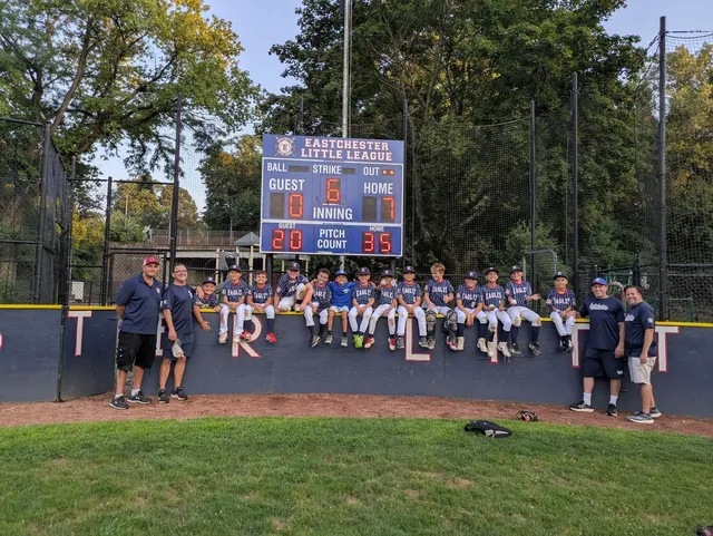 Eastchester Little League baseball team photo with scoreboard